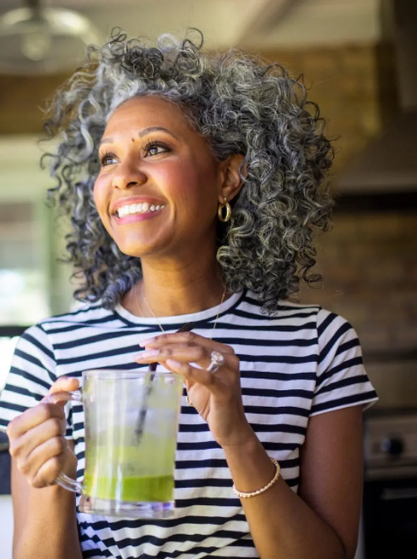 Smiling woman with grey curls, women's wellness